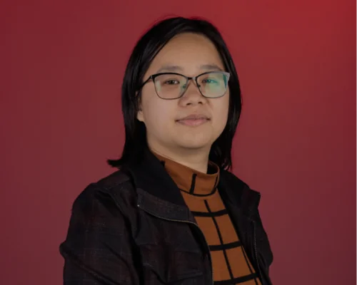 Portrait of Casey Chung against a red backdrop