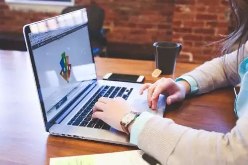 Woman using design software on a macbook