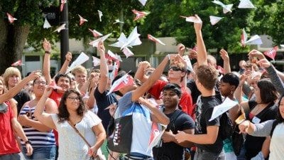 New Polk State freshmen launch their paper airplanes, on which they'd written words of encouragement for one another, at Thursday's First Flight Convocation.