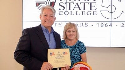 U.S. Congressman Dennis Ross visited the Polk State Clear Springs Advanced Technology Center on Wednesday to present a flag flown in honor of the building to President Eileen Holden.