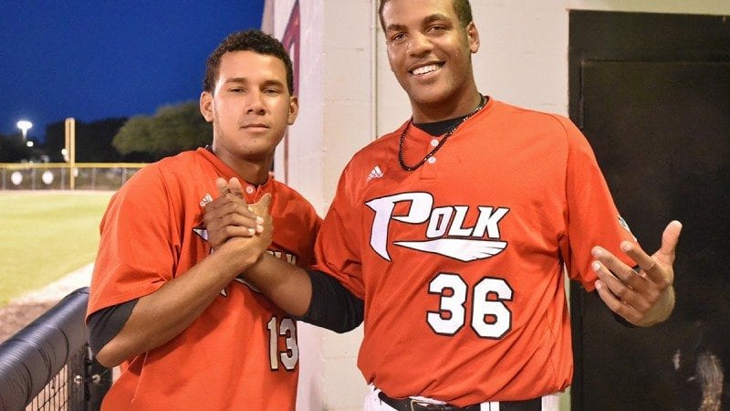 Former Polk State baseball players Maikor Mora (L) and Jordan Gurrero, who were selected in this year's MLB draft, pose in the dug out during an April 18 game. Casey Schroeder, not pictured, was also drafted.