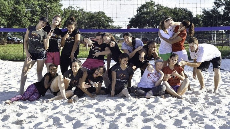 Polk State volleyball players and coaches enjoy the new sand volleyball court on the Winter Haven campus.