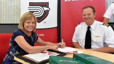 Polk State President Eileen Holden and ExpressJet First Officer and Pilot Recruiter Jared Allison celebrated a new partnership on Tuesday that will give Aerospace students access to ExpressJet mentors and preferential hiring benefits.