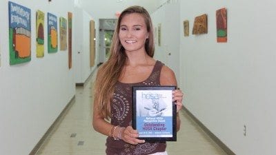 Sydney Weber displays the Outstanding HOSA Chapter award Polk State Chain of Lakes Collegiate received at HOSA's national competition in late June.