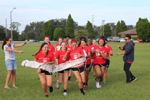 The juniors break through their class banner, ready to take down the seniors.