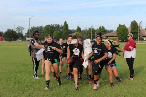 The seniors break through their class banner, which reads Seniors 2017, ready to battle the juniors for the win.