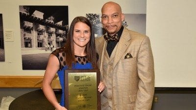 On behalf of the soccer team, Sarah McKinney accepts Academic Team of the Year Award from Vice President for Student Services Reggie Webb.