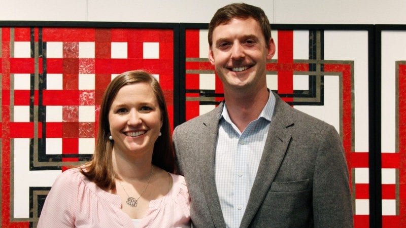 Sydney Bovino (L) and Courtney Baker stand in front of one of the many pieces of art created by their father, Gary Baker, a longtime Polk State professor. Many of Gary Baker's works are being auctioned to raise money for student scholarships. The Gary Baker Memorial Exhibition will remain on display at the Polk State Winter Haven Fine Arts Gallery through April 23.