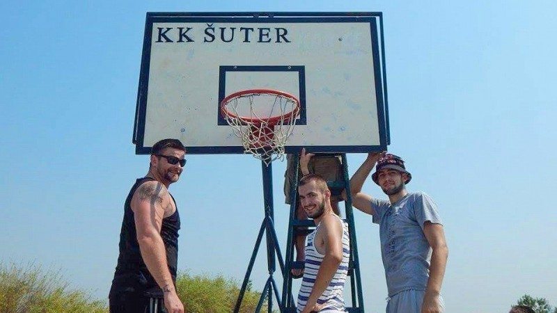 Polk State basketball player Djuro Pantos, right, with volunteers who helped renovate a basketball court in Belgrade, Serbia.