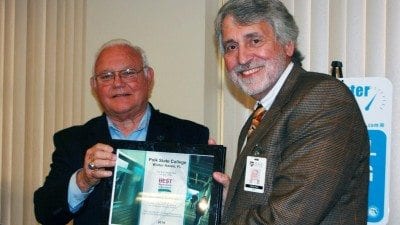 County Commissioner Edwin Smith (L) presents Polk State Lakeland Provost Steve Hull with the Best Workplaces for Commuters award on Tuesday.