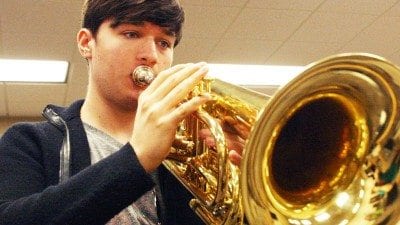 Polk State Chain of Lakes Collegiate High School student Andrew Sallee practices the baritone, the instrument he will play in this year's Macy's Thanksgiving Day Parade.