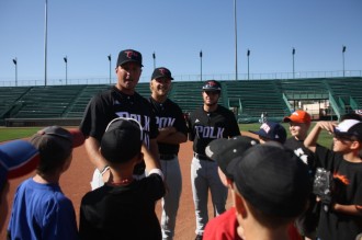 Polk State Baseball Head Coach Al Corbeil and players Conor Szczerba and Colt Hankamer (L-R) instruct children on making double-plays during the 12th-annual JuCo Youth Clinic on Thursday in Grand Junction, Colo.