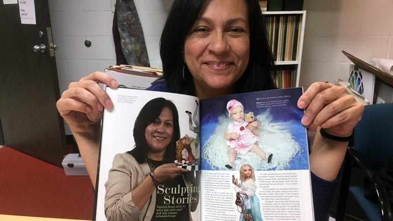 Polk State student Patty Rowe holds the October 2016 edition of Dolls magazine, which includes a feature on her and her work.