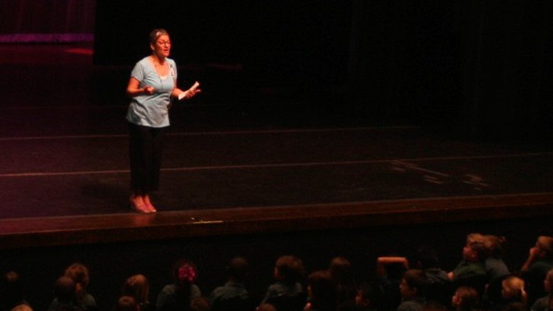 Polk State Theatre Adjunct professor Ilene Fins addresses more than 600 second-graders prior to the start of "All Kids Read with Polk State" on Thursday.