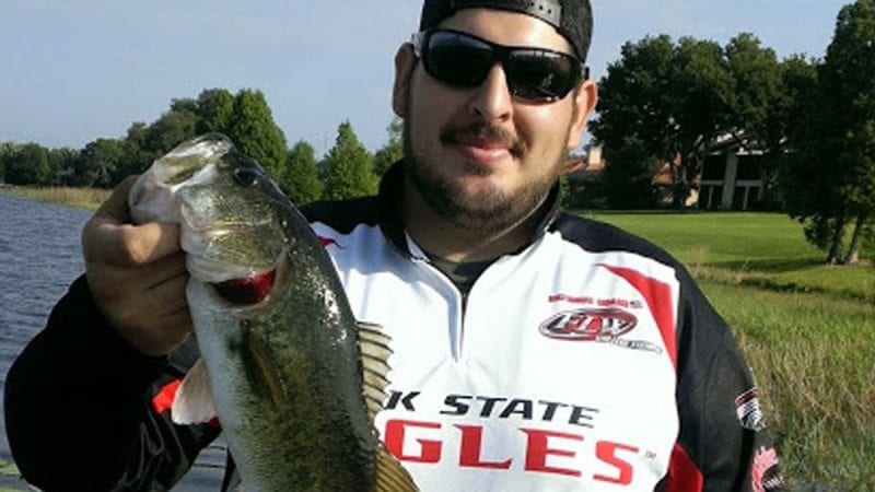 Andy Cruz displays a bass he caught in Winter Haven. Cruz is a member of Polk State's Bass Fishing Team, which has earned national rankings and spots in national competitions just two years after it began.