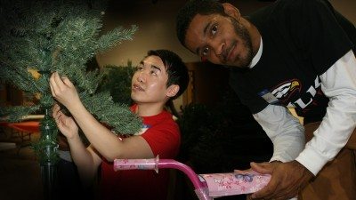 Chris Ly (L) and Pedro Martinez were among a dozen or so Polk State Lakeland students who volunteered at Parker Street Ministries to assemble the annual Christmas Store.