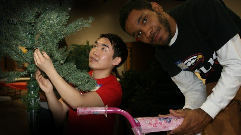 Chris Ly (L) and Pedro Martinez were among a dozen or so Polk State Lakeland students who volunteered at Parker Street Ministries to assemble the annual Christmas Store.