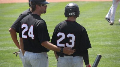 Assistant Coach Collin Martin, left, confers with Ryne Knuth (OF) during the Eagle's final game of the NJCAA JUCO World Series. Martin filled in for Head Coach Al Corbeil, who left Grand Junction, Colo., early to be with his wife, who gave birth to their first son early Tuesday morning.