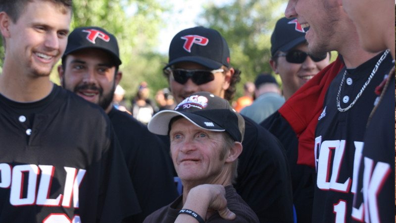 Les Payne, who is served by Mesa Developmental Services, shows off a Polk State arm band given to him by members of Polk State Baseball during a picnic Thursday at Western Colorado Botanical Gardens.