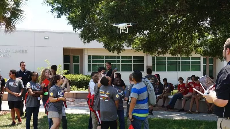 Participants in Polk State College's TALON Robotics program watch as a drone whizzes over their heads during a presentation on Friday. Polk State Aerospace Program Director Eric Crump, far right, gave the drone presentation.