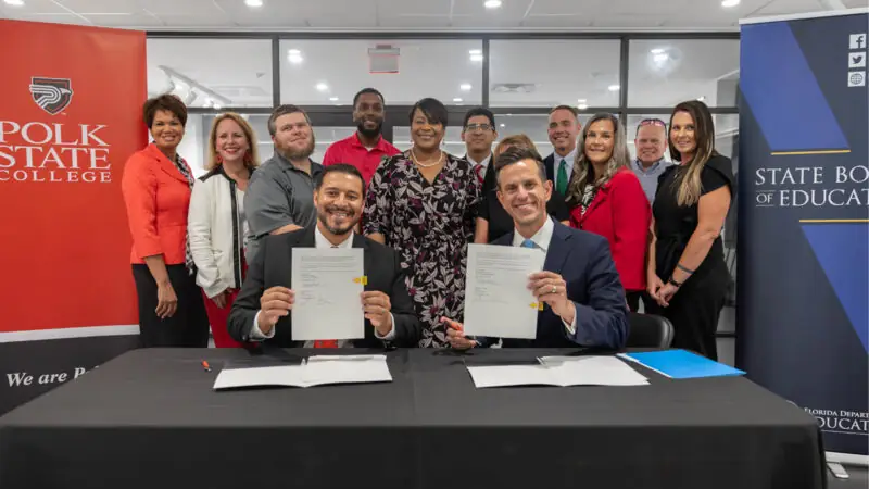 President Kamoutsas, Chancellor Mack and supports during signing ceremony.