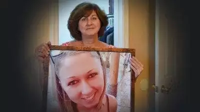 Janice Honiker holds a photo of her daughter, Michelle, who died earlier this year of a drug overdose. Janice has started a nonprofit called Michelle's Closet, which helps women in drug treatment. Janice graduates from Polk State with her Bachelor of Applied Science in Supervision and Management on Dec. 17.