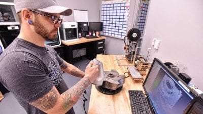 Charles Nixon, manager of Polk State's 3D print shop, demonstrates some of the technology students will use in the 3D printing classes now being offered at the Polk State Clear Springs Advanced Technology Center.