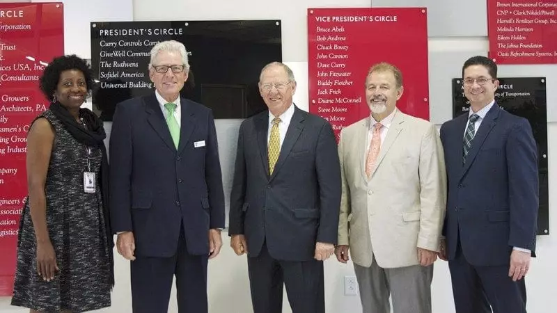 From left, Polk State Corporate College Business Development Coordinator Stephanie Campbell, Polk State Corporate College Director Rob Clancey, Pennoni founder and chairman C.R. "Chuck Pennoni, Pennoni executive vice president and chief administrative officer Nelson Shaffer, and Envisors division manager Steven Elias during a tour of the Polk State Clear Springs Advanced Technology Center on Friday.