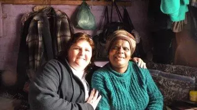 Polk State student Janis Davis Jones (L) is visiting townships near Cape Town, South Africa, while attending the Golden Key International Honour Society's South African Conference.