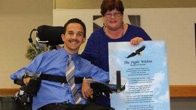 Garrett Putnam with Mary Westgate, Polk State's disability services coordinator. Westgate presented Putnam with a laminated version of his poem, "The Fight Within," during last month's Criminal Justice Teach-In.