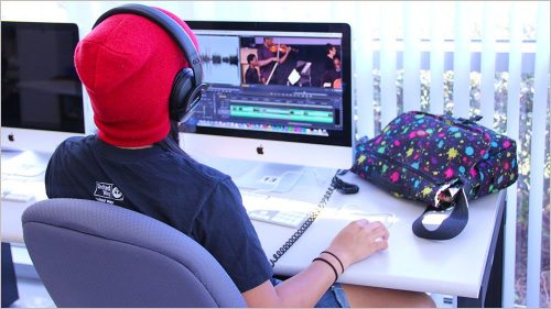 Student editing video in lab